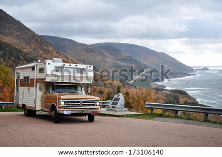 CABOT TRAIL, NOVA SCOTIA - OCTOBER 19, 2013:  A vintage 70's motor home stops at a look-off on the Cabot Trail in the fall to enjoy the scenic view.