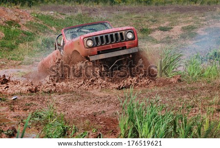 PLEASANT VALLEY, NOVA SCOTIA - AUGUST 27, 2011 - A vintage Scout 4x4 with its top down blasts through a mud bog.