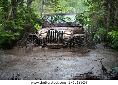 Mount Uniacke, Nova Scotia - July 4, 2009: A Jeep Drives Through A Deep Mud Bog But Ends Up Getting Stuck.