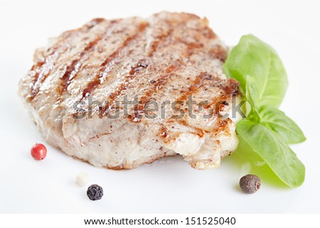 Grilled steak on white plate closeup