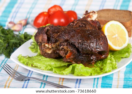 Roast leg of lamb on decorated table