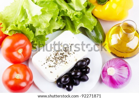 Ingredients for a Greek salad - vegetables, olive oil and feta cheese