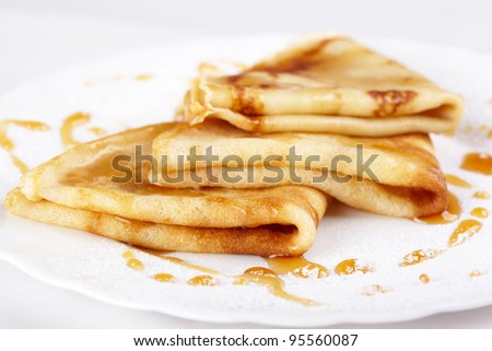 Thin pancakes with honey and powdered sugar
