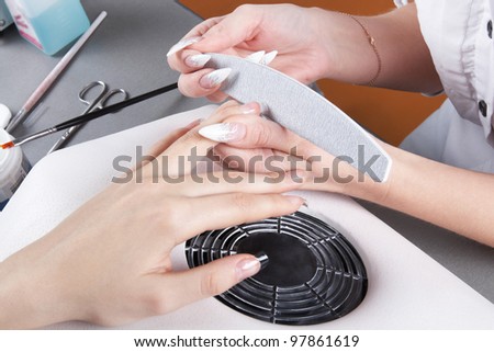Manicure. Processing of extended nails by a nail file