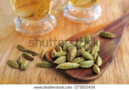 Green cardamom with green tea in glasses cup