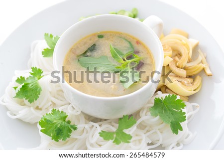 Thai vermicelli eaten with curry and vegetable on old wood table,Thai vermicelli eaten with curry,noodle,boiled Thai rice vermicelli, usually eaten with curries or Thai style ,