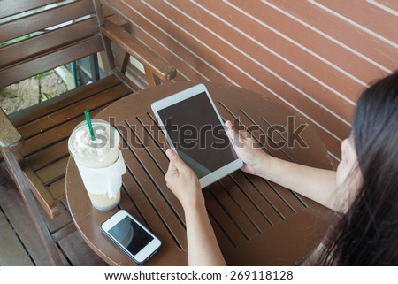 woman work on your  laptop and drinking coffee in cafe