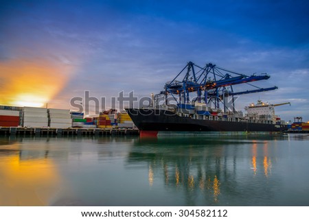Cargo ship loading containers by crane in the morning , Trade Port , Shipping