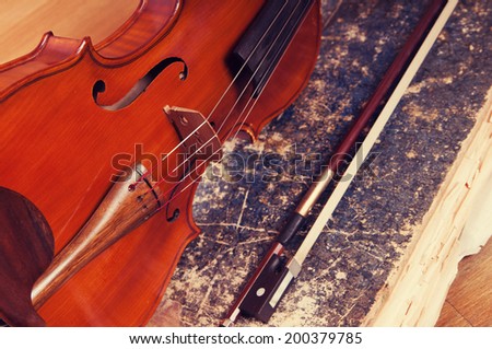 Violin, bow and old book table