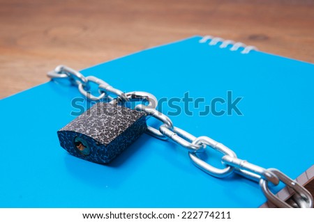 Notebook with chain and padlock, concept of protection of personal information