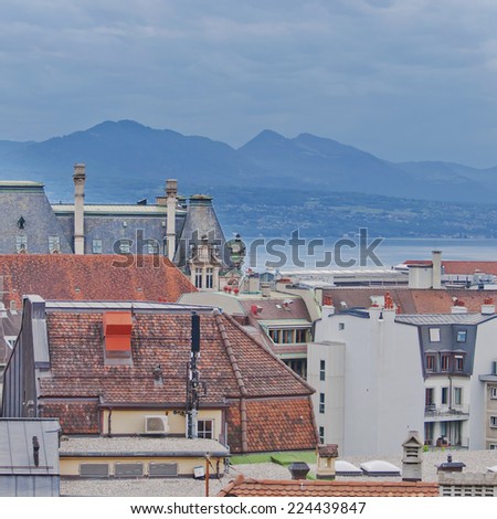 Skyline of Lausanne, Switzerland as seen from the Cathedral hill. Lake Leman (Lake Geneva) and the French Alps provide a beautiful background.