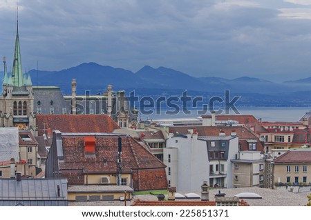 Skyline of Lausanne, Switzerland as seen from the Cathedral hill. Lake Leman (Lake Geneva) and the French Alps provide a beautiful background.