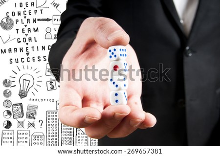 close up of mans hand holding white casino dice