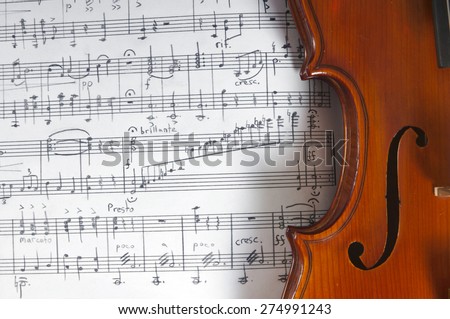 Music notes and violin on table