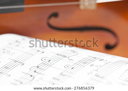 Music notes and violin close up