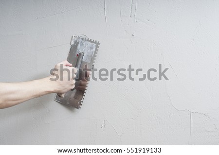 Hands Plasterer at work. Application of the plaster on the wall. textured plaster