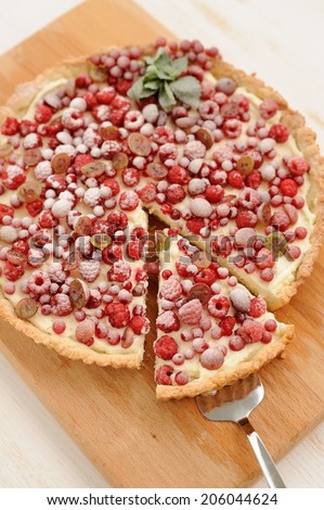 Berry pie with whipped cream filling and sugar powder