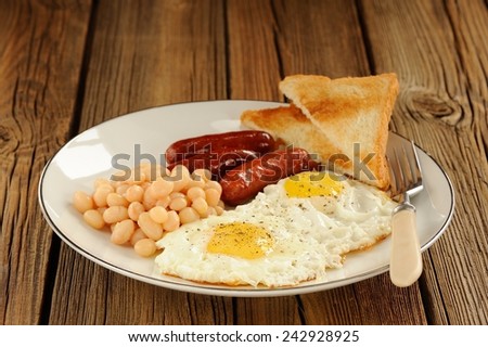 Full english breakfast with eggs, sausages, beans, toasts