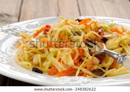 Cabbage ragout with carrot, chili and beans and mushrooms closeup macro