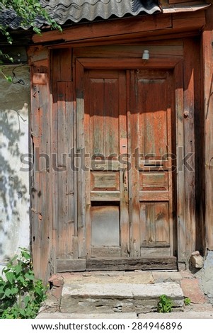 Old wooden door painted brown
