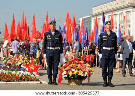 Orel, Russia - August 5, 2015: two military men laying flowers on eternal flame
