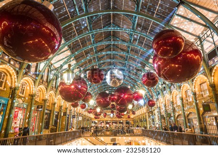 Apple market in Covent Garden in London NOV 16, 2014. The modern colorful Christmas lights attract and encourage people to the market.