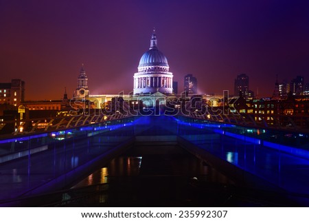 Millennium Bridge leads to Saint Paul\'s Cathedral in central London at night, cross processing