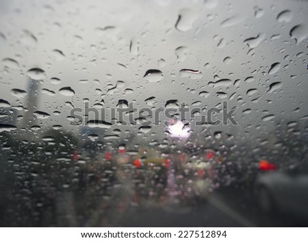 Raindrops on glass. Outside window evening on street