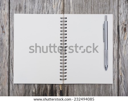 Blank page of book paper with pen on wooden background.Top view Background object with text space