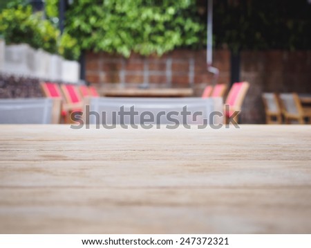 Top of Wooden table with Blurred restaurant cafe Background