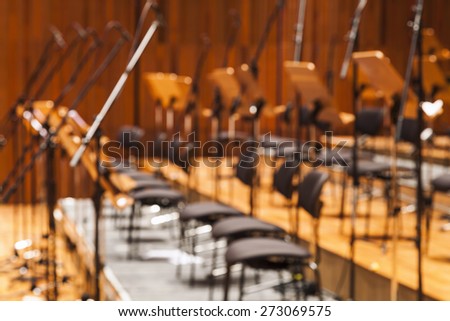 Blurred Orchestra stage with chairs and microphone as Background