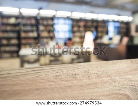 Table top with Blurred book store shelf background in perspective