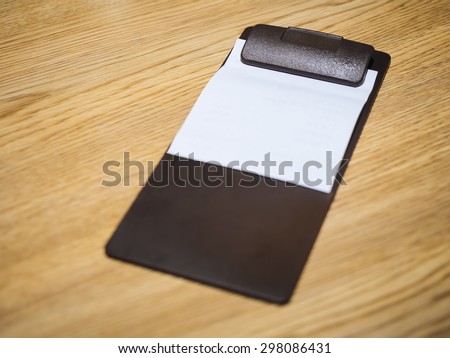 Blank Bill Receipt Restaurant Clip in pad on Table