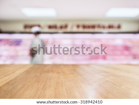 Table Top counter with Blurred Fresh food Meat display in Supermarket