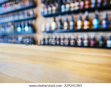 Table top Counter with Blurred Wine Liquor bottles Display Background