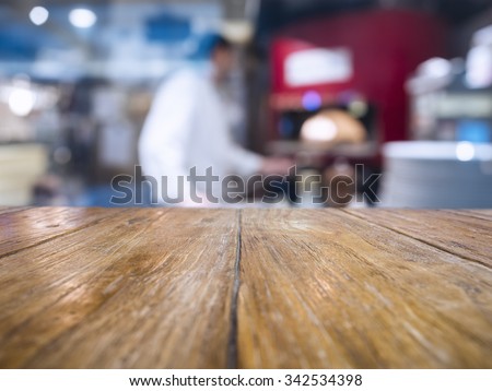 Table Top with Blurred Chef Cooking Pizza Italian restaurant Background