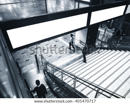 Blank Banner Billboard Media Display with Escalator Stairs and people in subway station