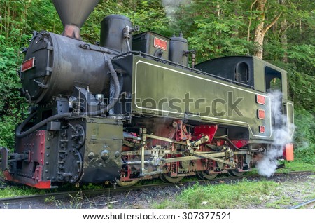 Old black steam powered railway train. Restored old vintage steam train built at Resita, Romania.