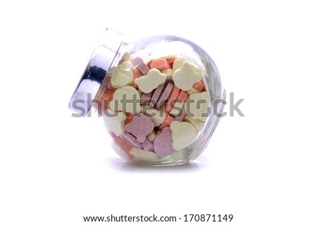 Various Color And Shape Of Tablet Vitamins In A Glass Jar Over White Background