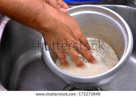 Men Hands Washing Rice In The Pot At The Sink