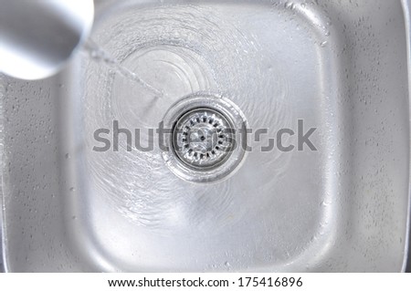 Water Flowing Down In The Hole In A Kitchen Sink