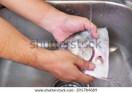 Men Hands Washing Fish Cut At The Sink