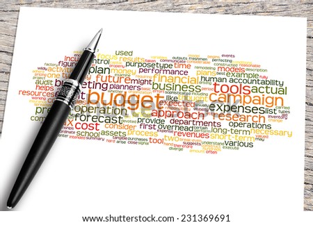 Close Up Pen And Paper On The Wooden Table With Budget Word Cloud And Its Related.