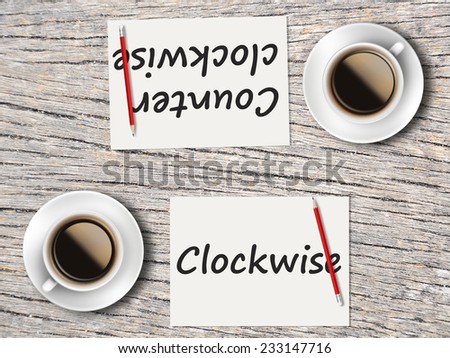 Business Concept (Rotatable) : Two Coffee, Papers And Pencils On The Table  Facing Each Other Head To Head To Compare Between Clockwise And Counter Clockwise.