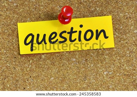Question word on notepaper with brown cork background