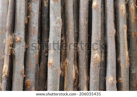 Many rows of timber are stacked high at a sawmill.