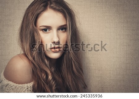 Young beautiful girl looking at camera, dramatic look, art portrait