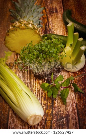 fresh organic vegetables and fruit variety on wooden floor