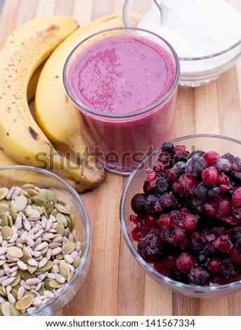 healthy berries juice smoothie on wooden board