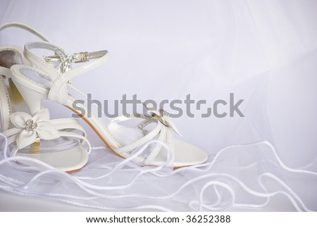 stock photo wedding sandals and flowers decoration over bridal veil